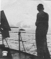 Lone sailor looking out to sea